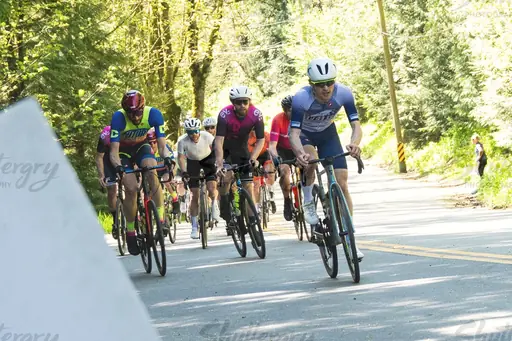 Manuel leading a bunch up a sunny forest road